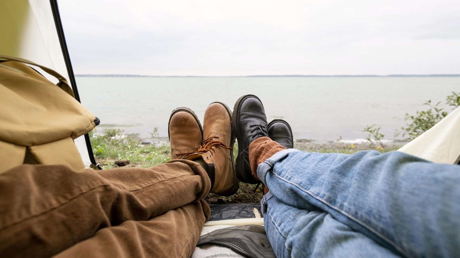 couple s feet reaching out tent scaled